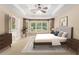 Staged bedroom featuring stylish furnishings, including a queen-size bed, nightstands, lamps, wall decor, and a decorative rug at 1235 Legend Run, Alpharetta, GA 30005