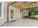 Brick patio with a wood pergola and a door to the main home at 1235 Legend Run, Alpharetta, GA 30005