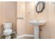 Charming powder room features pedestal sink, decorative mirror, and tile flooring at 1235 Legend Run, Alpharetta, GA 30005
