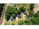 An aerial view of a home nestled among trees, showcasing its roof and surrounding landscape at 65 Ashland Farm Rd, Oxford, GA 30054