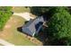 Lovely home boasts a large lot and is surrounded by lush greenery on a bright day at 65 Ashland Farm Rd, Oxford, GA 30054