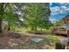 The backyard has mature trees and a trampoline, offering space for outdoor recreation and relaxation at 65 Ashland Farm Rd, Oxford, GA 30054