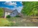 Spacious backyard with lush green grass and mature trees surrounding the property offers a tranquil outdoor space at 65 Ashland Farm Rd, Oxford, GA 30054