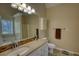 Bright bathroom featuring a modern vanity, bathtub and large mirror at 65 Ashland Farm Rd, Oxford, GA 30054