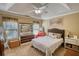 Bright bedroom featuring vaulted ceilings, soft neutral walls, and a cozy bed at 65 Ashland Farm Rd, Oxford, GA 30054
