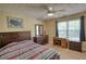 Bedroom featuring a large window for natural light, complemented by a traditional wooden desk and dresser at 65 Ashland Farm Rd, Oxford, GA 30054