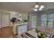 Bright dining area with a view to the kitchen and table with seating at 65 Ashland Farm Rd, Oxford, GA 30054
