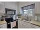 Modern kitchen with stainless steel appliances and window view at 65 Ashland Farm Rd, Oxford, GA 30054