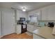 Cozy kitchen with ample counter space, white cabinetry, and stainless steel appliances at 65 Ashland Farm Rd, Oxford, GA 30054