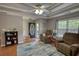 Inviting living room featuring a ceiling fan, a front door view, and comfortable seating at 65 Ashland Farm Rd, Oxford, GA 30054