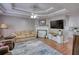 Cozy living room with a fireplace, ceiling fan, and wood-look flooring at 65 Ashland Farm Rd, Oxford, GA 30054