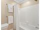 Bathroom featuring white tile, a shower, and white towels at 66 Devon Ln, Avondale Estates, GA 30002
