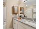 Bathroom showcasing granite countertop, white cabinets, and a mirrored medicine cabinet for ample storage at 66 Devon Ln, Avondale Estates, GA 30002