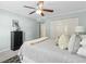 Bright bedroom featuring a ceiling fan, neutral walls, a comfortable bed, and closet storage at 66 Devon Ln, Avondale Estates, GA 30002