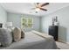 Bedroom showcasing a ceiling fan, natural light, and a comfortable bed with soft pillows and a throw at 66 Devon Ln, Avondale Estates, GA 30002