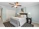 Well-lit bedroom featuring a ceiling fan, carpet, light blue walls, a window, and closet storage at 66 Devon Ln, Avondale Estates, GA 30002