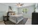 Comfortable bedroom with a ceiling fan, window, a patterned rug, and neutral decor at 66 Devon Ln, Avondale Estates, GA 30002