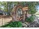 Avondale Estates brick entrance adorned with an arch and signage, surrounded by mature trees and landscaping at 66 Devon Ln, Avondale Estates, GA 30002