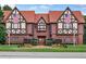 Charming Tudor-style home with brick facade, dark wood trim, and manicured landscaping at 66 Devon Ln, Avondale Estates, GA 30002