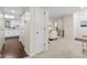 Hallway showing access to the kitchen and a living area, with wood and carpeted flooring at 66 Devon Ln, Avondale Estates, GA 30002