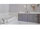 Bathroom featuring a tub and vanity with gray cabinets at 90 Fairlie Street Nw #801 # 801, Atlanta, GA 30303