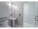 Bright bathroom features a pedestal sink and glass-enclosed shower at 90 Fairlie Street Nw #801 # 801, Atlanta, GA 30303