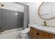 Bathroom features a stylish vanity with marble countertop, a subway tile shower, and modern fixtures at 1077 Shady Valley Ne Pl, Atlanta, GA 30324