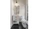 Cozy half bathroom with a white vanity and black and white patterned tile floor at 1077 Shady Valley Ne Pl, Atlanta, GA 30324