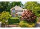 Charming home with stone accents, complemented by mature trees and lush landscaping at 1077 Shady Valley Ne Pl, Atlanta, GA 30324