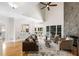Stylish living room with stone fireplace, connecting the kitchen and other living spaces at 1077 Shady Valley Ne Pl, Atlanta, GA 30324