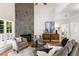 Spacious living room features a striking stone fireplace and comfortable seating arrangement at 1077 Shady Valley Ne Pl, Atlanta, GA 30324
