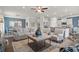 Bright living space with plush seating, a ceiling fan, and an open layout connecting the kitchen and dining area at 1315 Elowen Dr, Austell, GA 30168