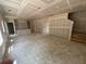 Large, unfinished living room with stairs and space to customize, with neutral paint and lighting at 2076 Boxwood Circle Se, Conyers, GA 30094