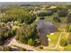 An aerial view showcasing a scenic lake, golf course, and lush greenery in the surrounding area at 679 Gold Valley Pass, Canton, GA 30114