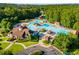 Aerial view of a large community pool area with slides, seating, and other amenities for summertime fun and relaxation at 679 Gold Valley Pass, Canton, GA 30114