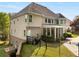 Expansive backyard features a screened porch, black metal fence, lush greenery, and a tranquil setting at 679 Gold Valley Pass, Canton, GA 30114