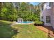 Spacious backyard featuring a swimming pool, gazebo, and lush landscaping, ideal for outdoor entertaining and relaxation at 679 Gold Valley Pass, Canton, GA 30114