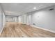 Finished basement with wood-look floors, stylish tiled ceiling, and a full wall mirror, perfect for a home gym at 679 Gold Valley Pass, Canton, GA 30114