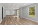 Bright basement space features stylish floors, recessed lights, and a large window overlooking the backyard at 679 Gold Valley Pass, Canton, GA 30114