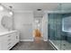 Bright bathroom features a marble countertop vanity and separate glass shower at 679 Gold Valley Pass, Canton, GA 30114