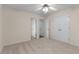 Bright bedroom with neutral carpet, ceiling fan and double-door closet, offering ample storage at 679 Gold Valley Pass, Canton, GA 30114