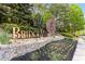 Beautiful stone entrance sign for BridgeMill with lush greenery and a water wheel feature at 679 Gold Valley Pass, Canton, GA 30114