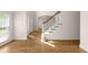 Light-filled foyer featuring hardwood floors, staircase, and a view to the front door and window at 679 Gold Valley Pass, Canton, GA 30114