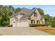 Charming home boasts a three-car garage, brick accents, well-manicured landscaping and a spacious driveway at 679 Gold Valley Pass, Canton, GA 30114
