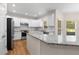 A modern kitchen with white cabinets, stainless steel appliances, and granite countertops and island at 679 Gold Valley Pass, Canton, GA 30114