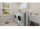 Convenient laundry room with a sink, counter space, storage cabinet, washer, and dryer at 679 Gold Valley Pass, Canton, GA 30114