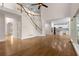 Open floor plan featuring hardwood floors, large windows, staircase, and a view to the modern white kitchen at 679 Gold Valley Pass, Canton, GA 30114