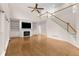 Bright living room features a cozy fireplace, built-in bookshelves, hardwood floors, and a staircase to the second floor at 679 Gold Valley Pass, Canton, GA 30114