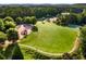 Large grassy field with a playground and walking path surrounded by mature trees at 679 Gold Valley Pass, Canton, GA 30114