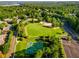 Aerial view of a park with a playground, basketball court, and a large grassy area surrounded by trees at 679 Gold Valley Pass, Canton, GA 30114